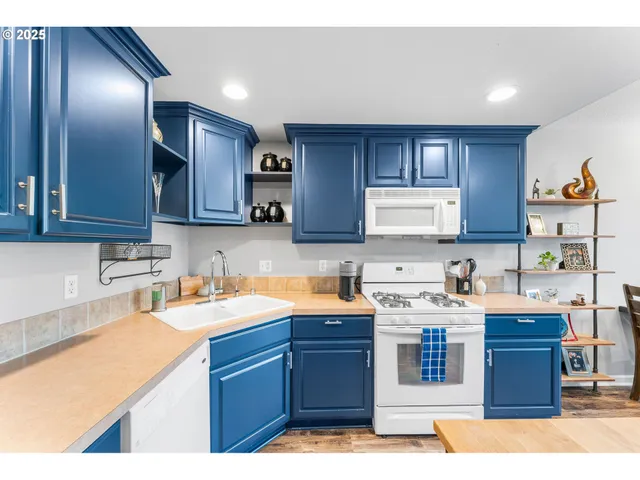 a kitchen with a sink a stove and cabinets