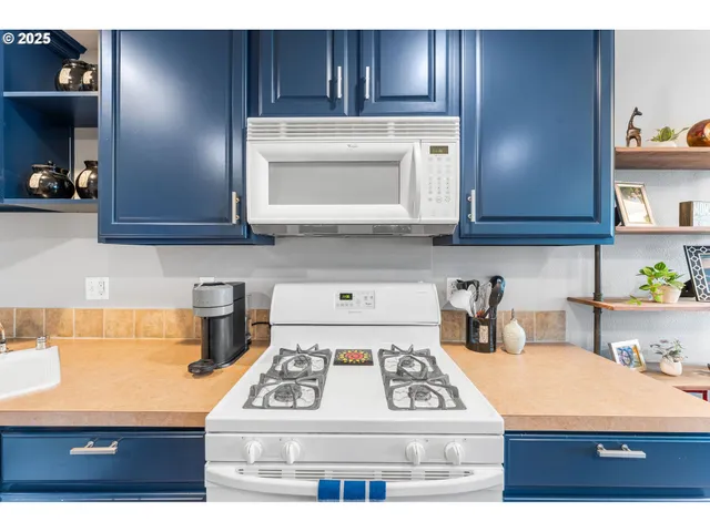 a kitchen with cabinets and appliances