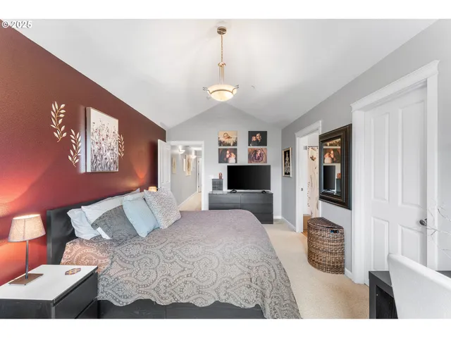 a bedroom with a large bed and a tv