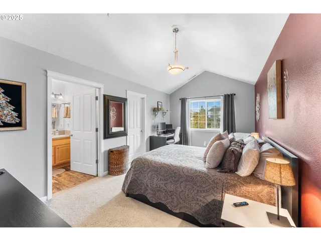 a bedroom with a large bed and a dresser