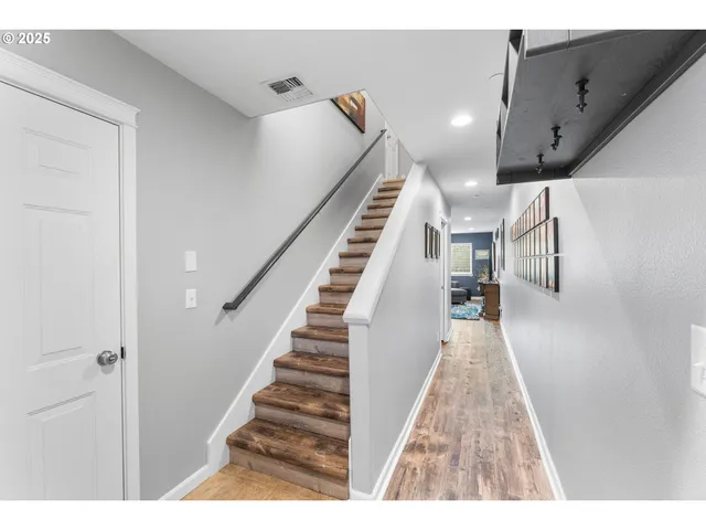 a view of entryway and hall with wooden floor