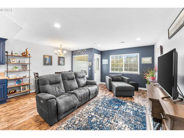 a living room with furniture a flat screen tv and a window