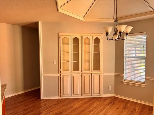 a view of a windows and wooden floor in a room