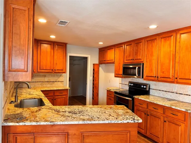 a kitchen with a stove a sink and a refrigerator