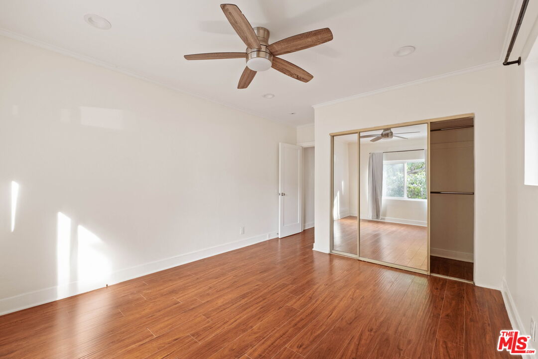 838 North Ridgewood Place Los Angeles, CA 90038 - Photo 15 of 23 a view of empty room with wooden floor and ceiling fan
