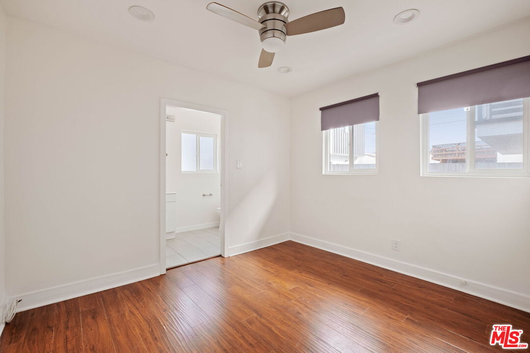 838 North Ridgewood Place Los Angeles, CA 90038 - Photo 16 of 23 wooden floor in an empty room with a window
