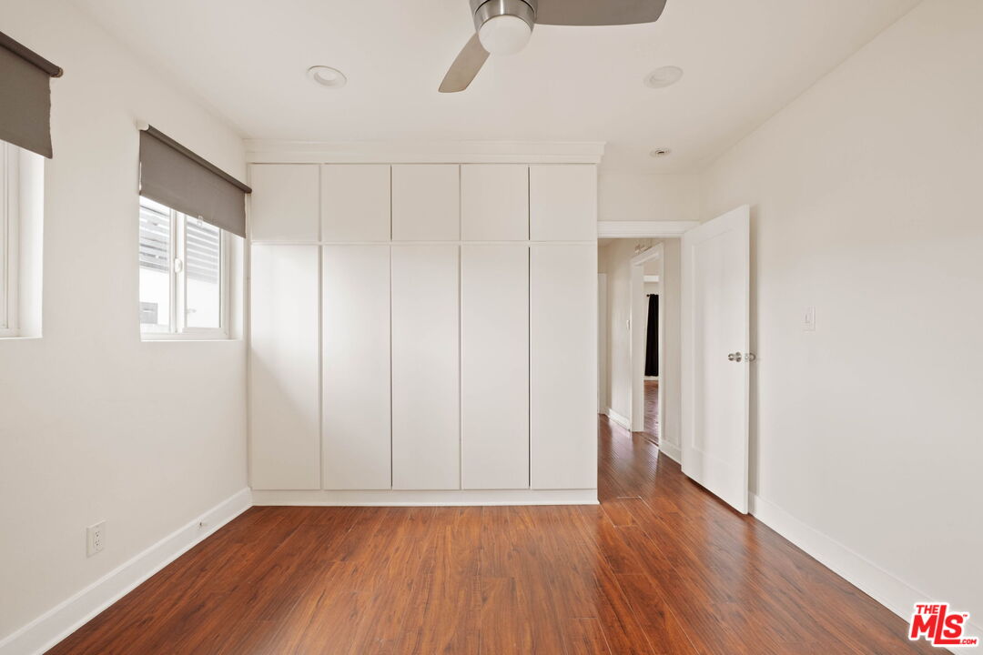 838 North Ridgewood Place Los Angeles, CA 90038 - Photo 17 of 23 a view of an empty room with wooden floor