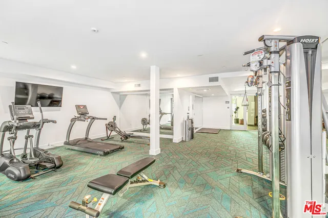 a view of a livingroom with furniture and gym equipment