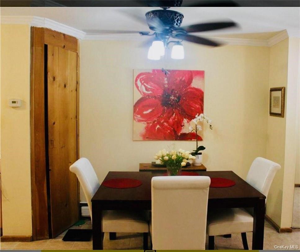 1 Secora Road, Unit B17 Monsey, NY 10952 - Photo 3 of 9 a view of a dining room with furniture and a chandelier fan