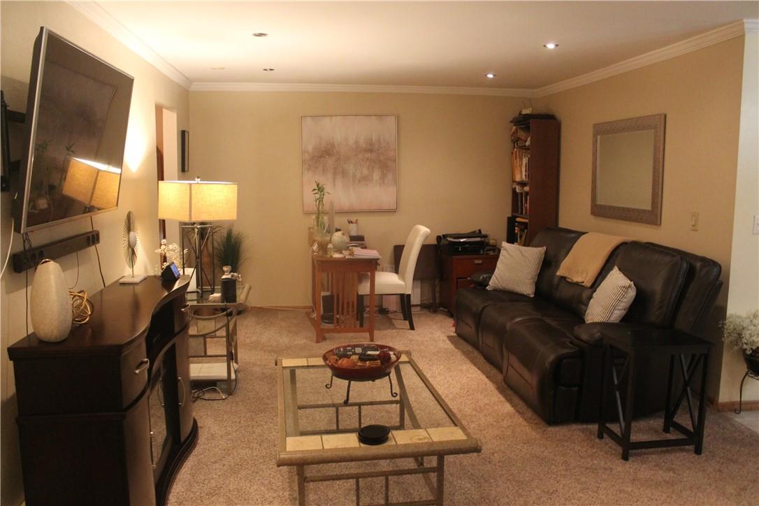 1 Secora Road, Unit B17 Monsey, NY 10952 - Photo 5 of 9 a living room with furniture wooden floor and a flat screen tv