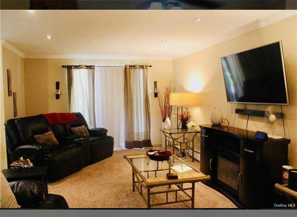 1 Secora Road, Unit B17 Monsey, NY 10952 - Photo 6 of 9 a living room with furniture and a flat screen tv