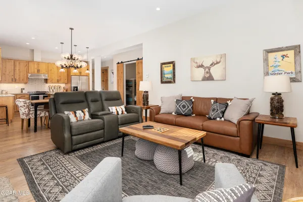 a living room with furniture and a chandelier