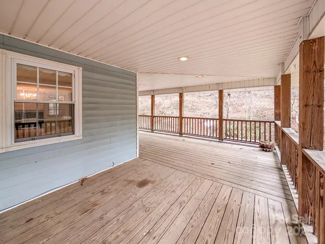 a view of a porch with wooden floor and iron stairs