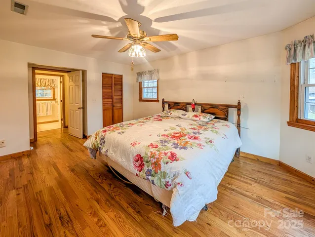 a bed sitting in a bedroom next to a window