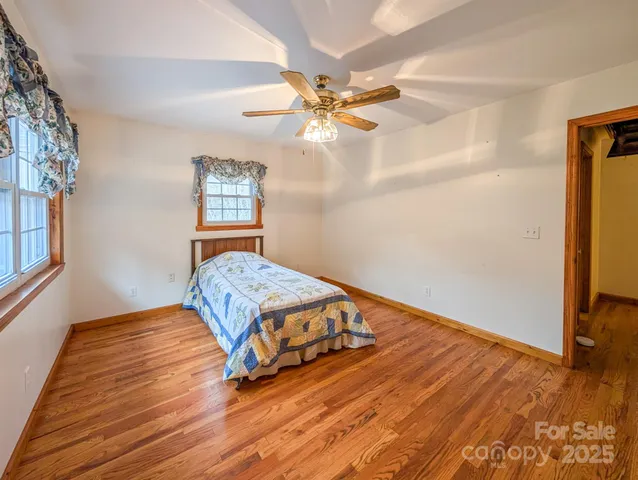 a room with wooden floor and window