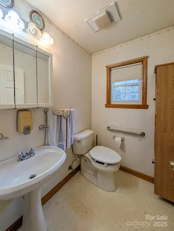 a bathroom with a sink mirror and toilet