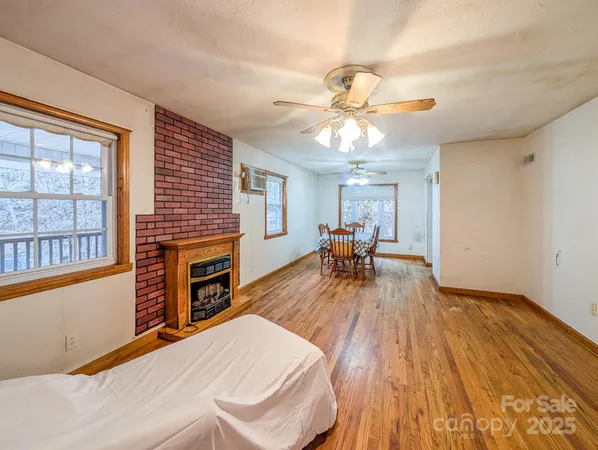 a view of a livingroom with furniture a ceiling fan and window