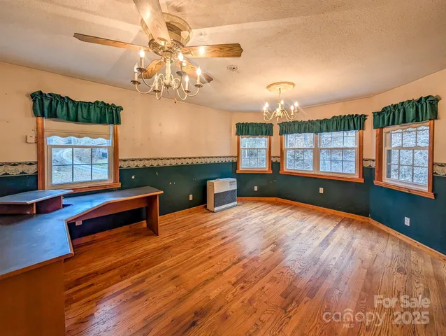 a view of a room with window and wooden floor