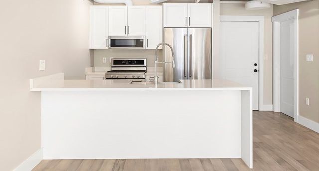 a kitchen with a sink and a refrigerator