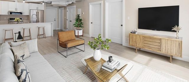 a bedroom with a bed and a flat tv screen on dresser