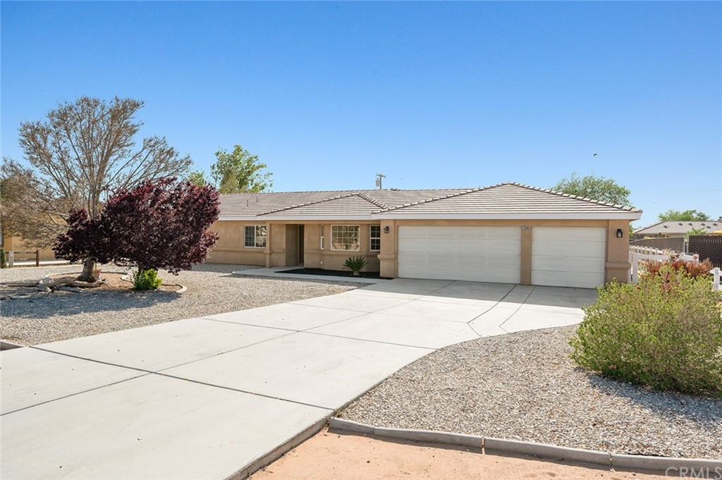 13508 Tutelo Road Apple Valley, CA 92308 - Photo 1 of 1 a front view of house with garage and yard