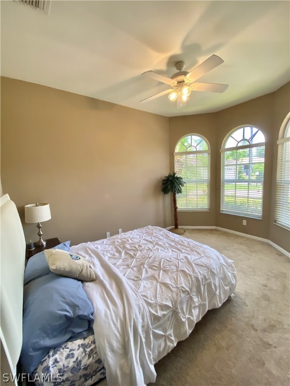 9012 West Ridge Court Fort Myers, FL 33912 - Photo 14 of 23 a bedroom with a large bed and a large window