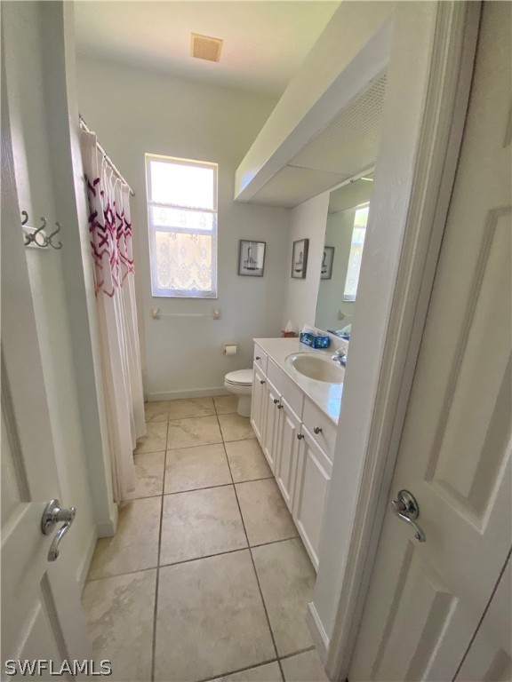 9012 West Ridge Court Fort Myers, FL 33912 - Photo 16 of 23 a bathroom with a sink a toilet a window and vanity