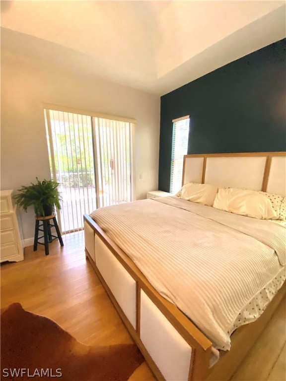 9012 West Ridge Court Fort Myers, FL 33912 - Photo 18 of 23 a spacious bedroom with a bed and a potted plant next to a window