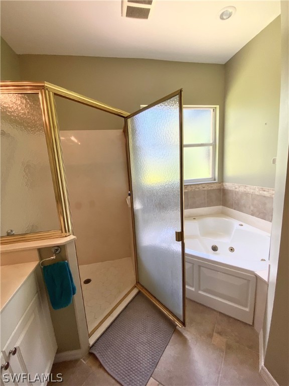 9012 West Ridge Court Fort Myers, FL 33912 - Photo 19 of 23 a bathroom with a bathtub and a shower