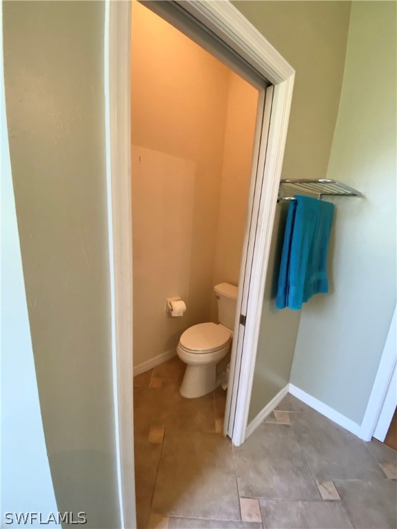 9012 West Ridge Court Fort Myers, FL 33912 - Photo 21 of 23 a bathroom with a granite countertop toilet and a sink