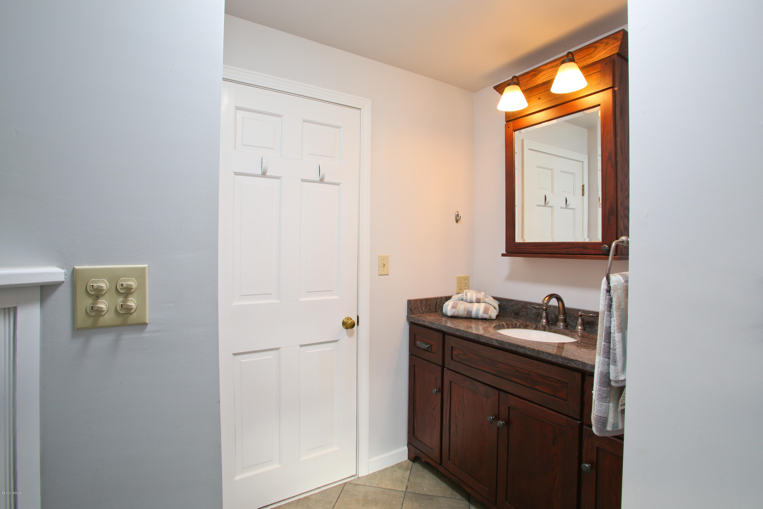 32 White Road Colrain, MA 01340 - Photo 22 of 34 a bathroom with a granite countertop sink and a mirror