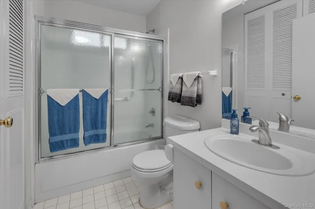 a bathroom with a toilet sink vanity and shower