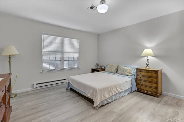 a bedroom with a bed and a lamp