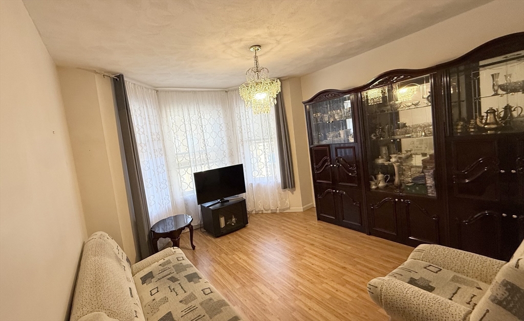 92 Gordon Street, Unit 301 Boston, MA 02135 - Photo 1 of 15 a view of a livingroom with furniture and a flat screen tv
