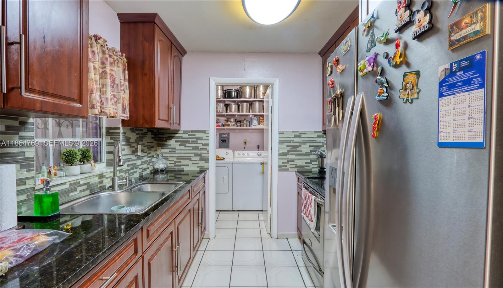 15825 Southwest 305th Terrace Homestead, FL 33033 - Photo 12 of 36 a kitchen with stainless steel appliances granite countertop a refrigerator and a stove