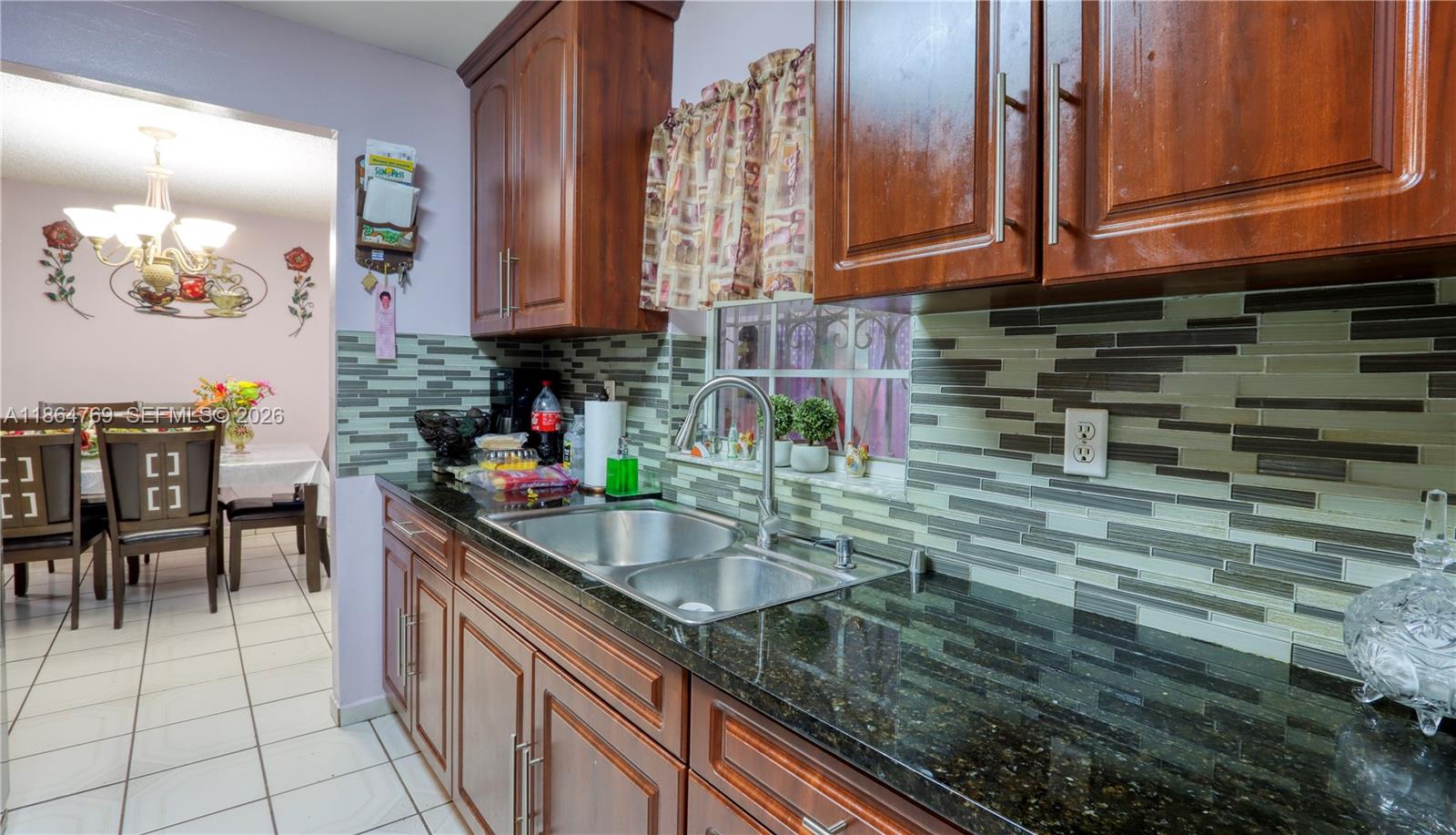 15825 Southwest 305th Terrace Homestead, FL 33033 - Photo 15 of 36 a kitchen with stainless steel appliances granite countertop a sink and cabinets