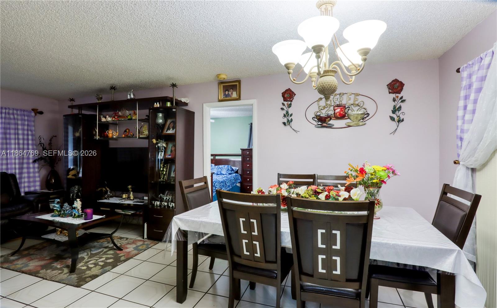 15825 Southwest 305th Terrace Homestead, FL 33033 - Photo 17 of 36 a view of a dining room with furniture and chandelier