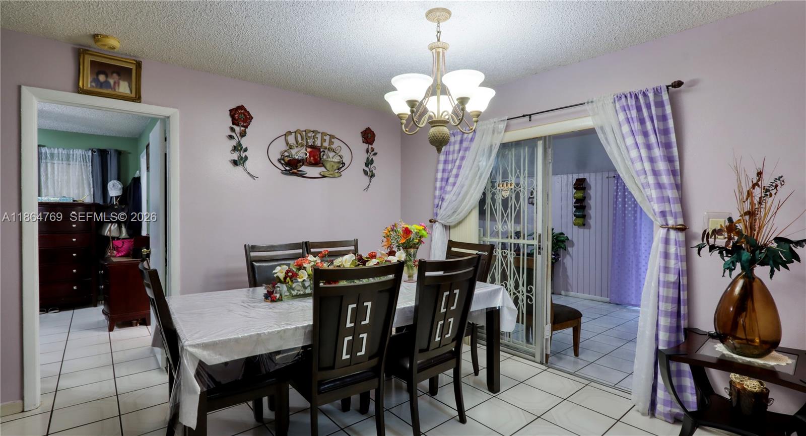 15825 Southwest 305th Terrace Homestead, FL 33033 - Photo 21 of 36 a view of a dining room with furniture and chandelier