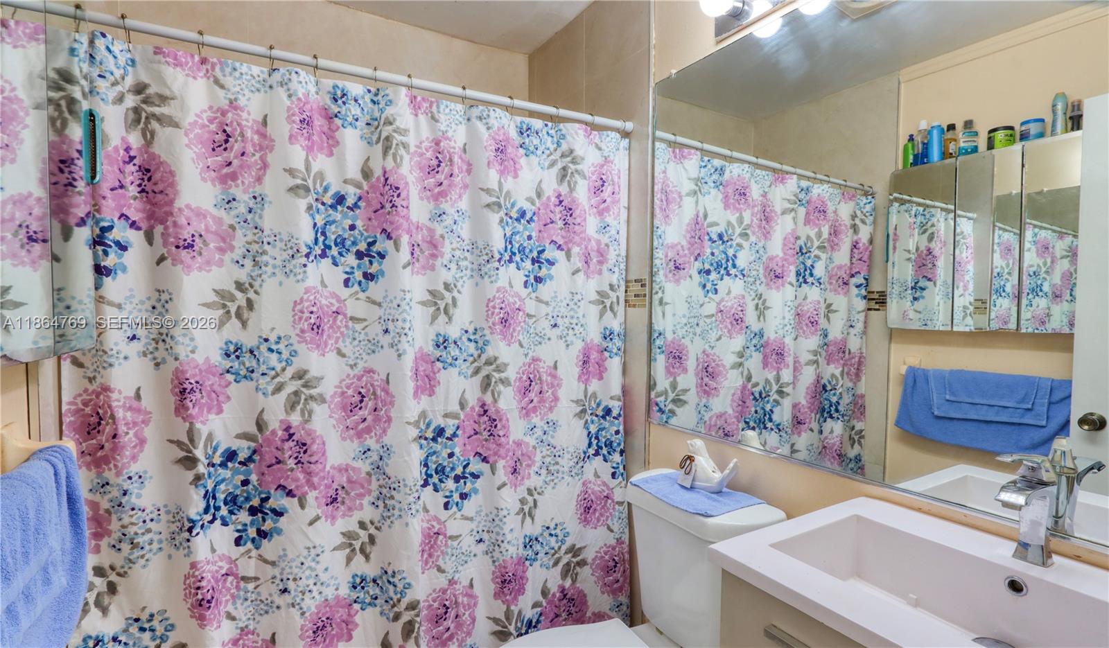 15825 Southwest 305th Terrace Homestead, FL 33033 - Photo 27 of 36 a bathroom with a sink toilet and shower curtain