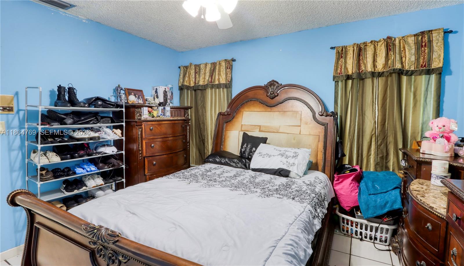 15825 Southwest 305th Terrace Homestead, FL 33033 - Photo 32 of 36 a bedroom with a bed and a book shelf