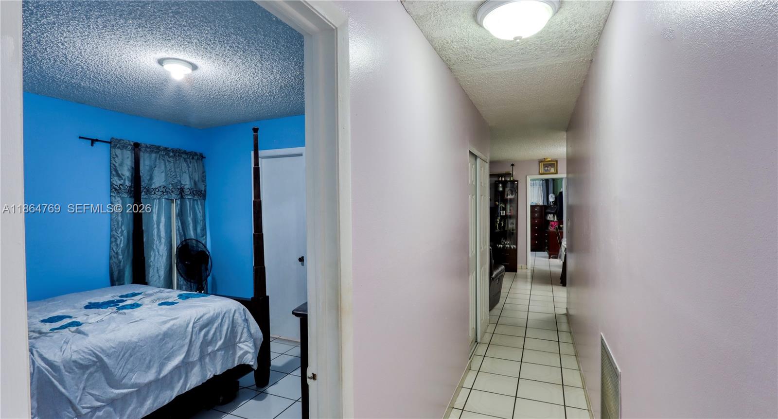 15825 Southwest 305th Terrace Homestead, FL 33033 - Photo 34 of 36 a bedroom with a bed and a view of bathroom
