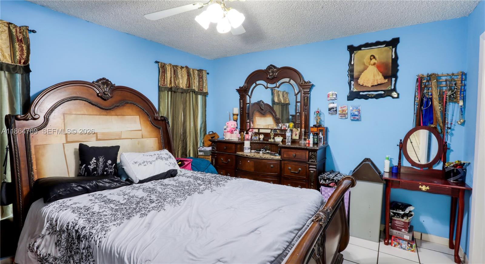 15825 Southwest 305th Terrace Homestead, FL 33033 - Photo 36 of 36 a bedroom with bed and a chandelier
