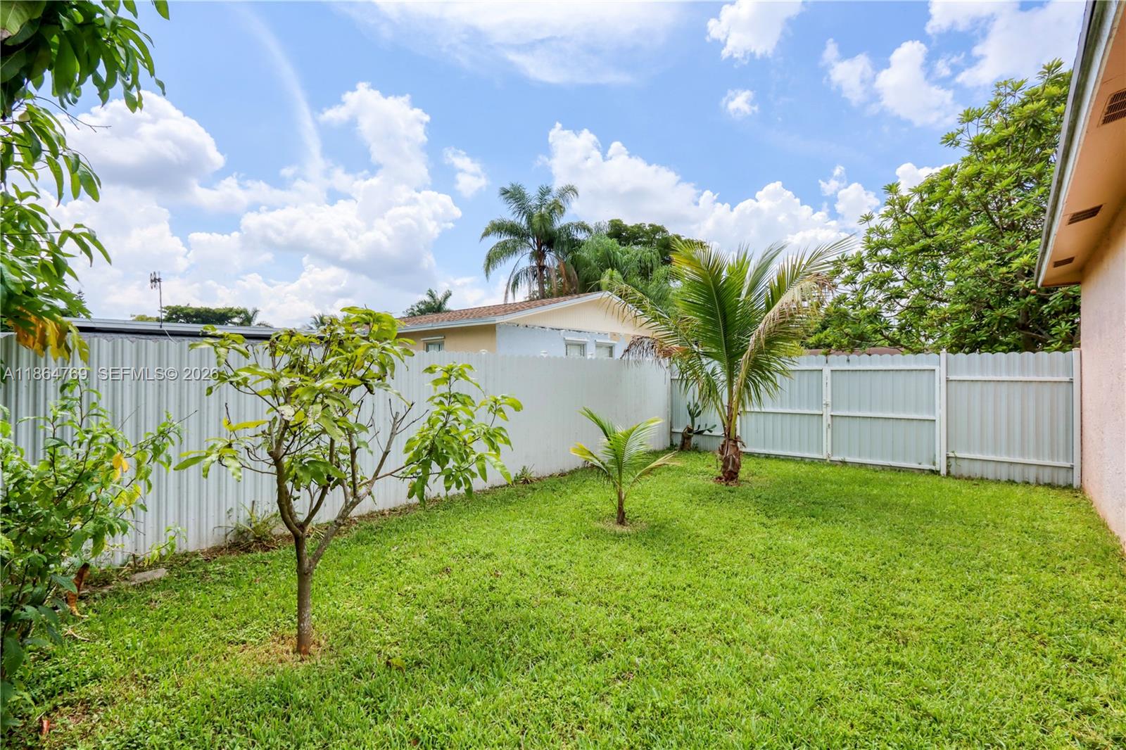 15825 Southwest 305th Terrace Homestead, FL 33033 - Photo 7 of 36 a view of a house with a backyard and a tree