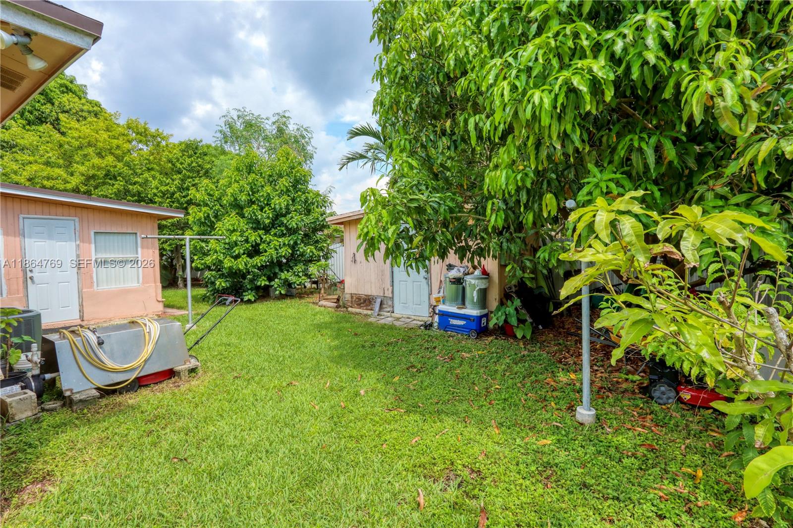 15825 Southwest 305th Terrace Homestead, FL 33033 - Photo 10 of 36 a view of a backyard with plants and a large tree