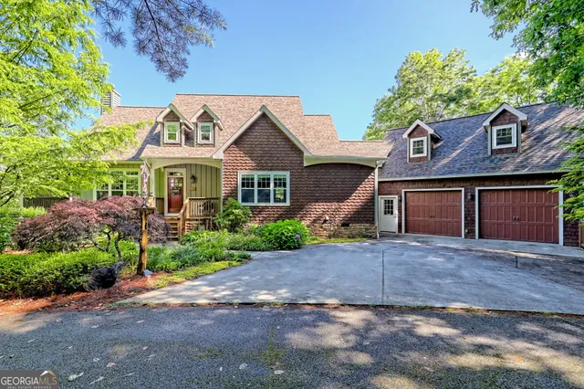 a front view of a house with a garden and plants