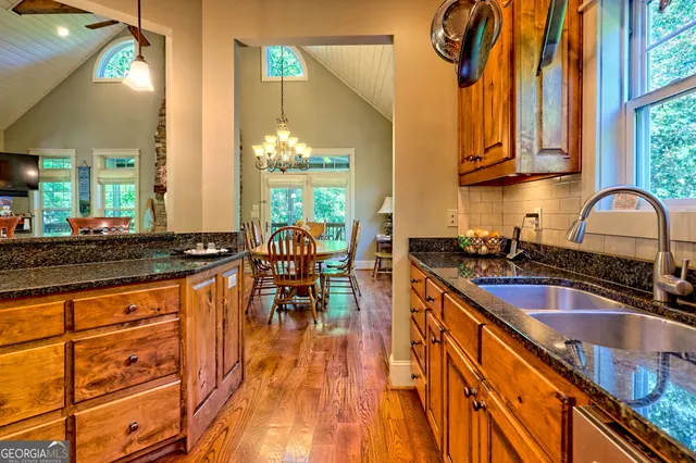 a view of balcony with wooden floor outdoor seating and yard in the back