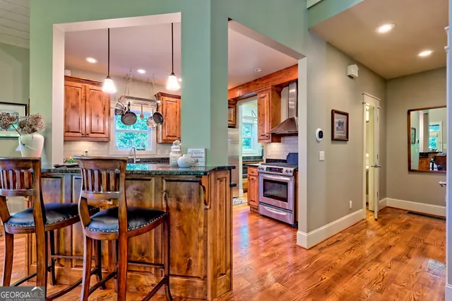 a view of a dining room with furniture a chandelier and wooden floor