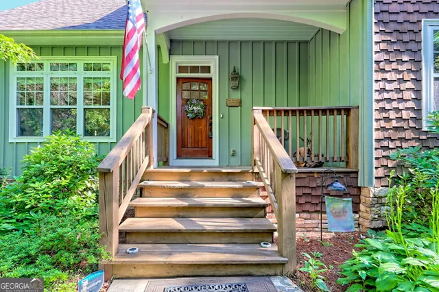 a living room with furniture a rug and a chandelier