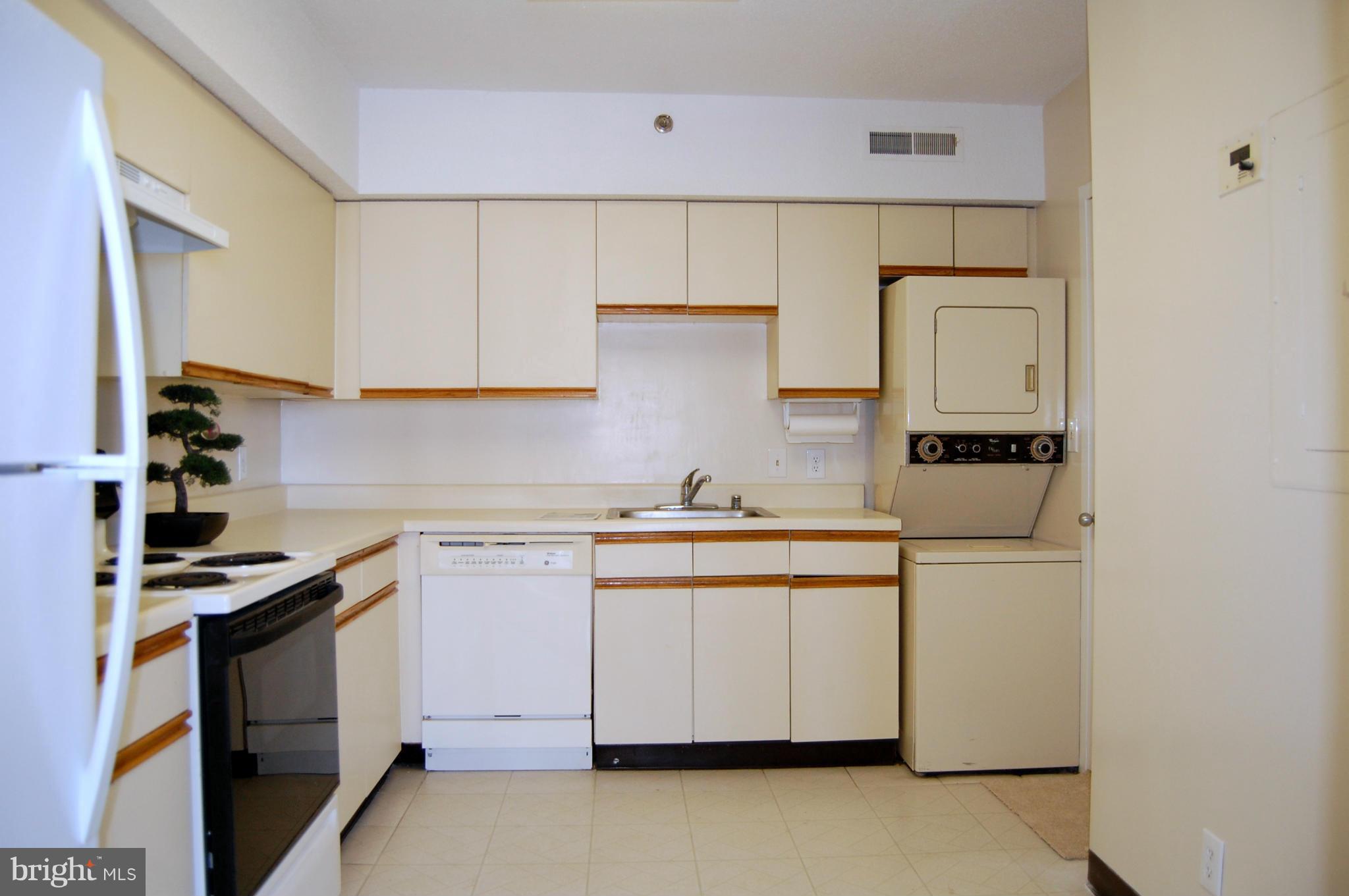 5505 Seminary Road, Unit 1407N Falls Church, VA 22041 - Photo 7 of 30 a kitchen with white cabinets and appliances