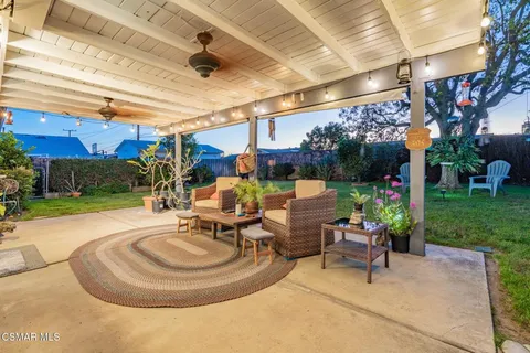 a view of a patio with a table and chairs